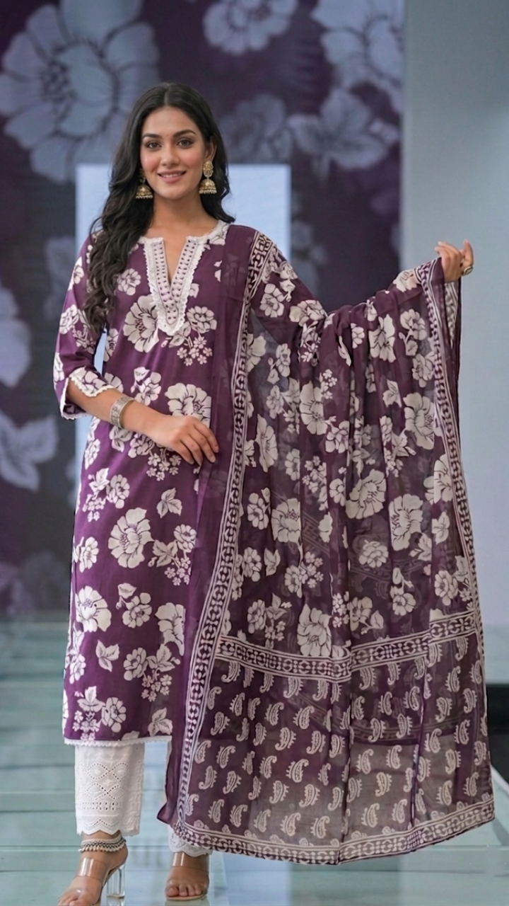 Woman wearing a Maroon floral kurta with white sifli pants and matching dupatta in a fashion show setting.